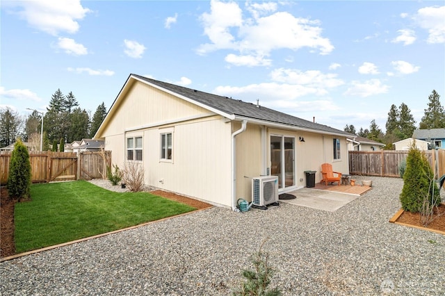 back of property featuring ac unit, a lawn, a fenced backyard, a patio, and a gate