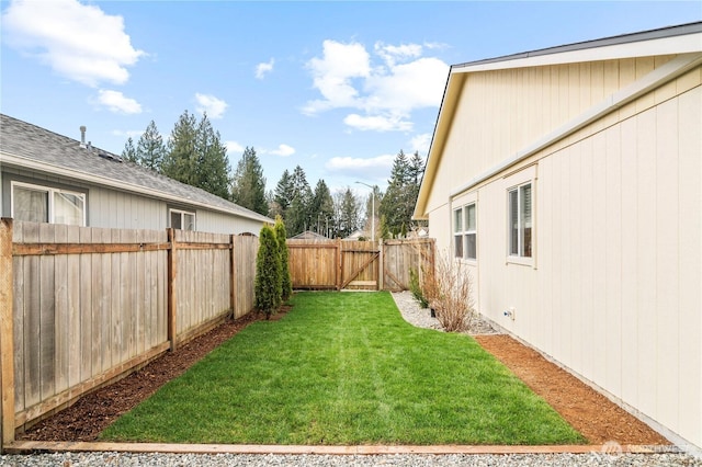 view of yard featuring a gate and a fenced backyard