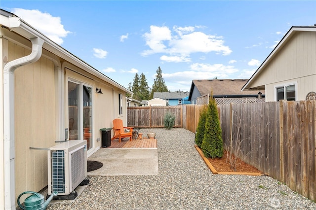 view of yard featuring a patio, central AC unit, and a fenced backyard