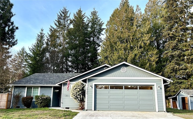 ranch-style home featuring an attached garage and driveway