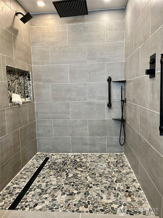 bathroom with tiled shower