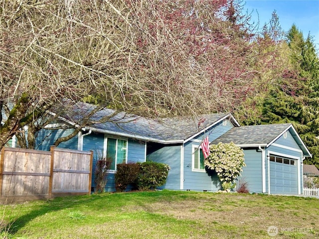 ranch-style home with crawl space, an attached garage, a front lawn, and fence