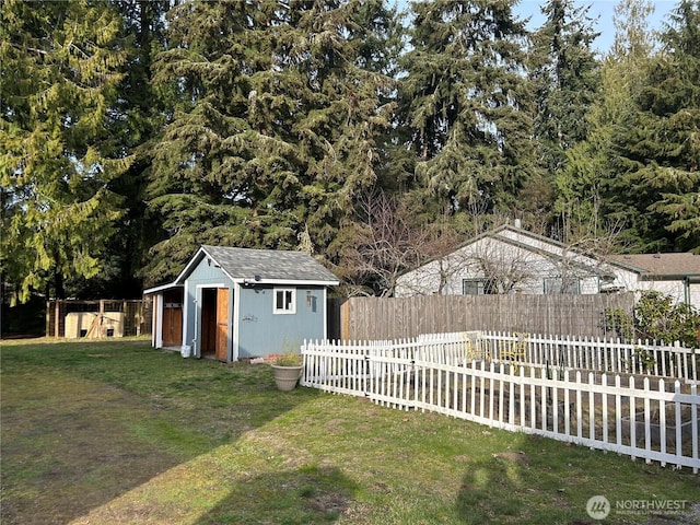 view of yard featuring a storage shed, an outdoor structure, and fence