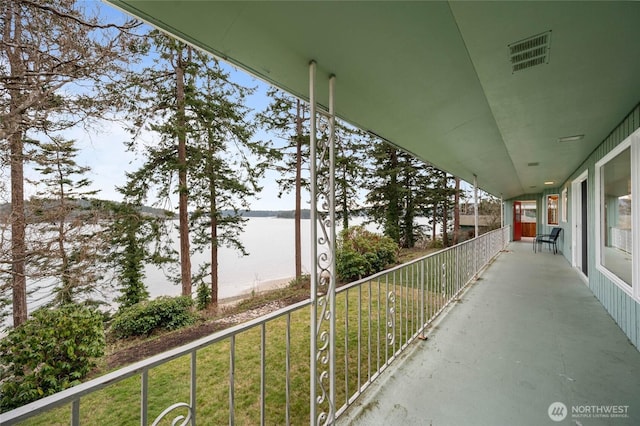 balcony with visible vents and a water view