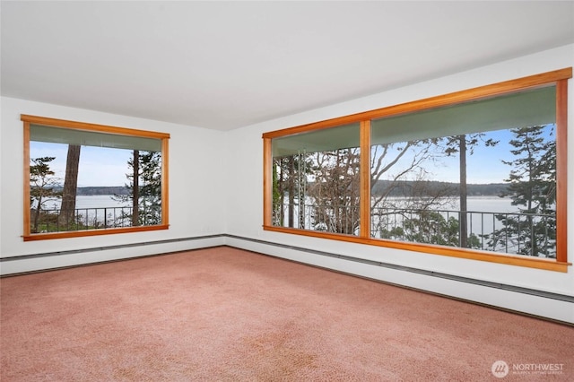 carpeted empty room featuring a baseboard radiator and a water view