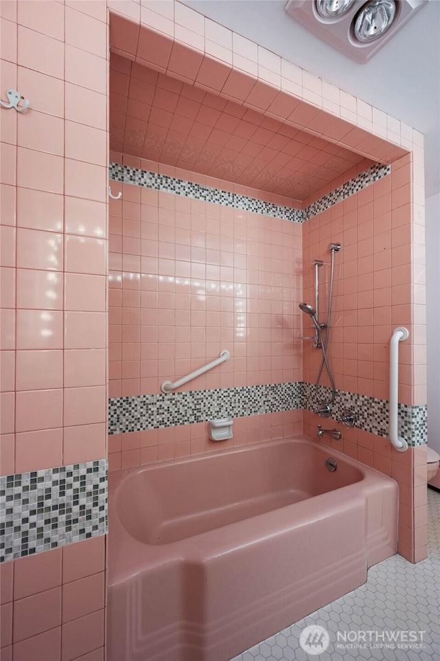 bathroom featuring tile patterned flooring, walk in shower, and a tub to relax in