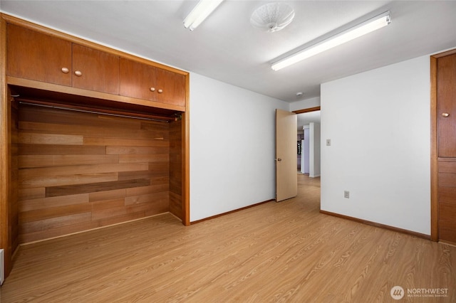 unfurnished bedroom featuring baseboards and light wood-style floors