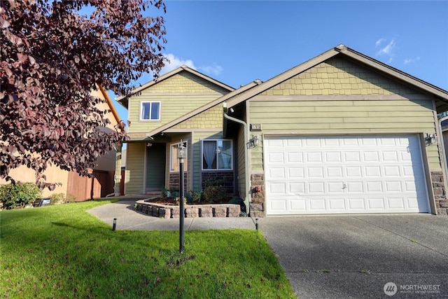 craftsman-style house featuring stone siding, a front yard, an attached garage, and driveway