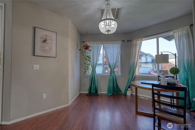 dining area featuring a wealth of natural light, visible vents, an inviting chandelier, and wood finished floors