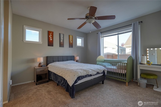 bedroom with a ceiling fan, baseboards, and carpet floors