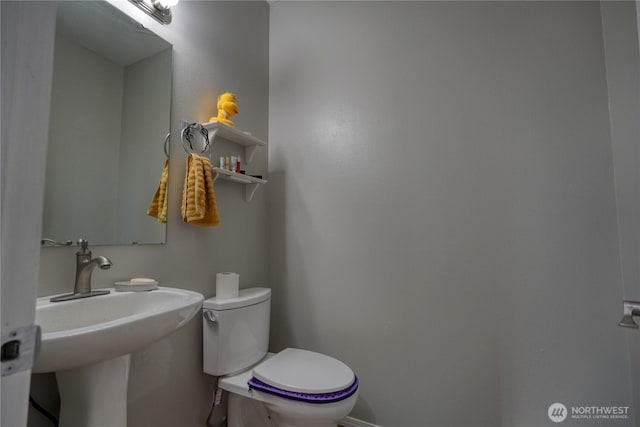 bathroom with toilet and a sink