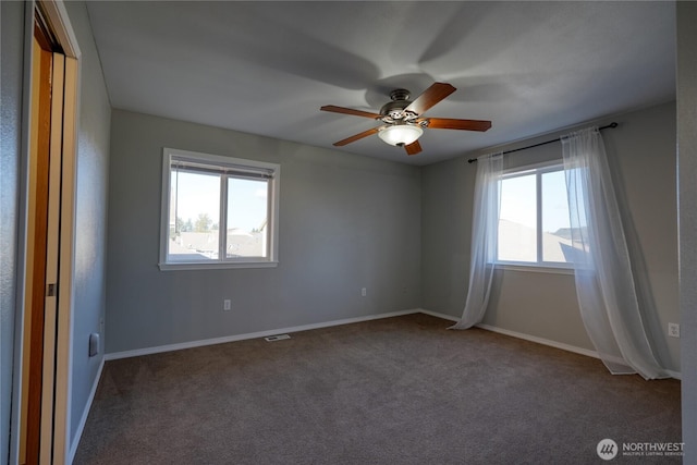 unfurnished room with baseboards, plenty of natural light, carpet floors, and ceiling fan