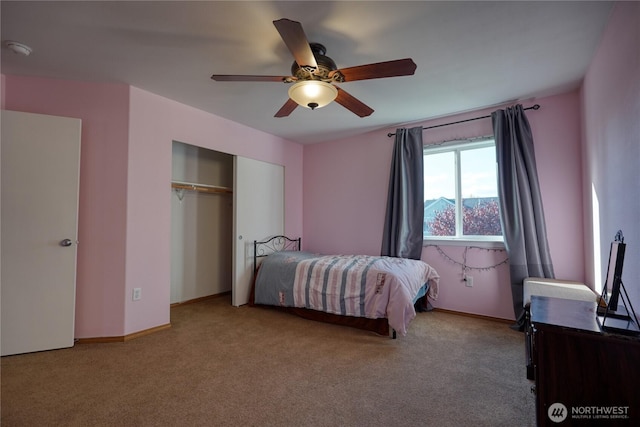 carpeted bedroom featuring a closet, ceiling fan, and baseboards