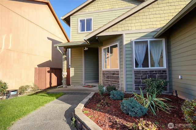 entrance to property featuring stone siding