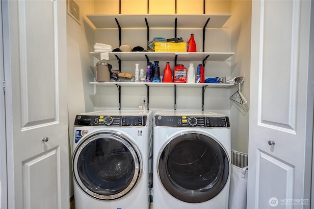 washroom with washer and dryer, laundry area, and visible vents