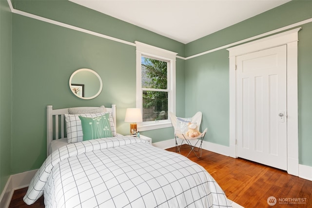 bedroom with wood finished floors and baseboards