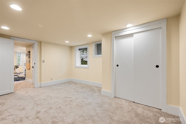 below grade area with a wealth of natural light, recessed lighting, baseboards, and carpet floors