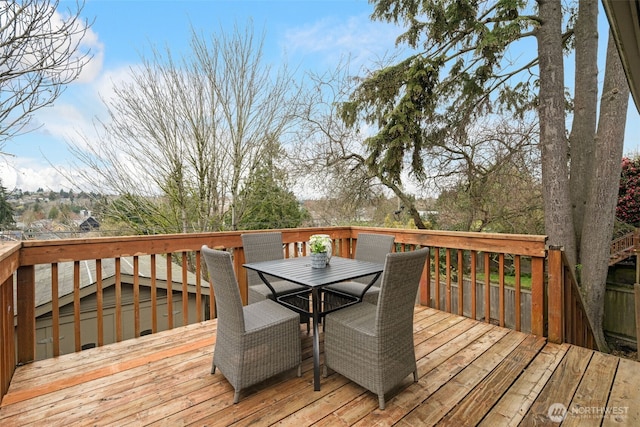 wooden terrace featuring outdoor dining space