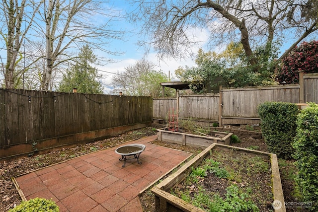 view of patio / terrace with a vegetable garden and a fenced backyard