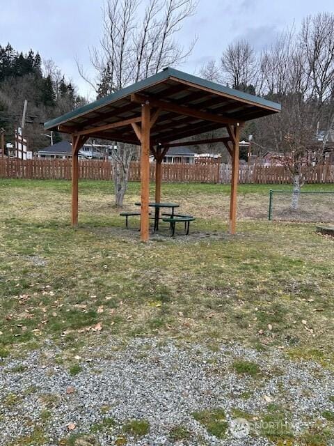 view of community with a gazebo, fence, and a lawn