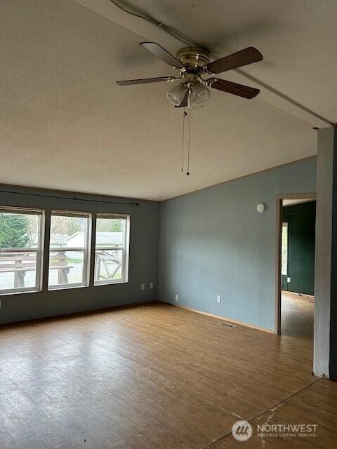 unfurnished room featuring vaulted ceiling, visible vents, and ceiling fan