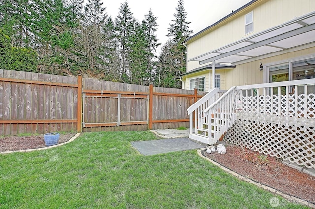 view of yard with fence and a wooden deck