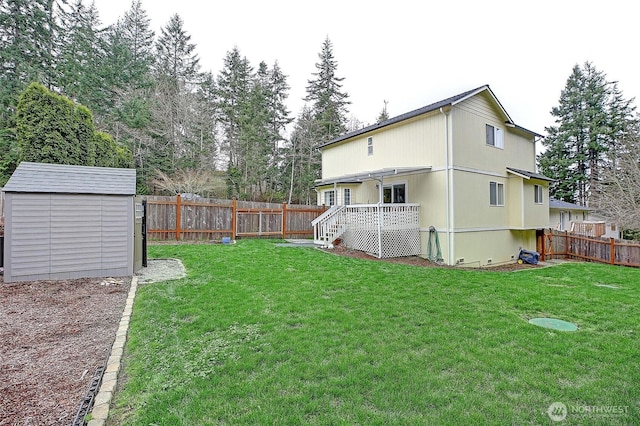 view of yard featuring a fenced backyard, a storage unit, and an outdoor structure