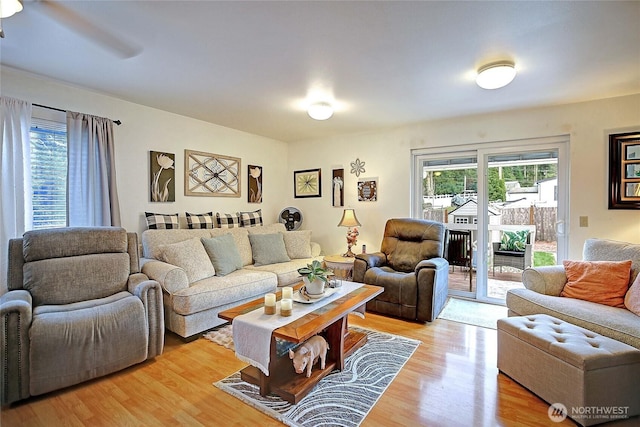 living room with a ceiling fan and light wood finished floors