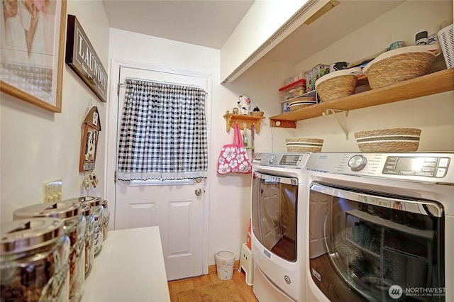 laundry room with laundry area, light wood-type flooring, and washing machine and clothes dryer