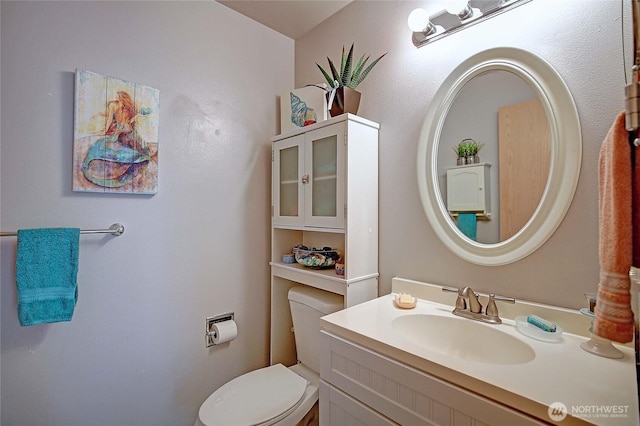 bathroom featuring vanity and toilet