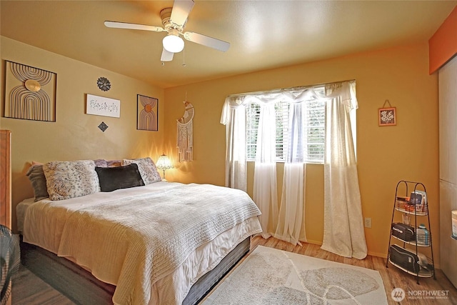 bedroom featuring wood finished floors and ceiling fan