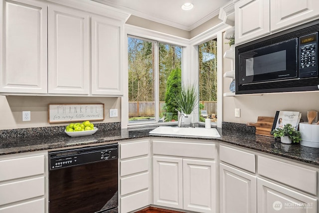 kitchen with black appliances, white cabinets, dark stone countertops, and a sink