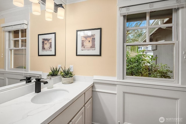 bathroom with ornamental molding and vanity