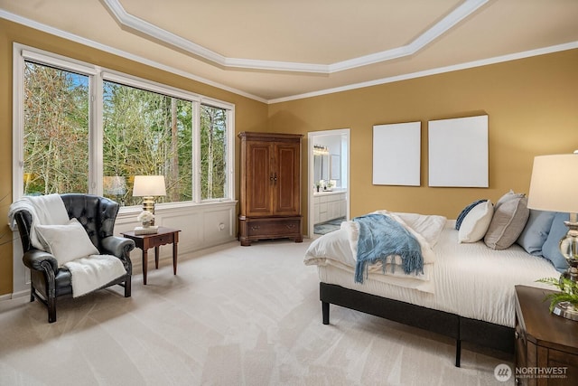 bedroom featuring light carpet, crown molding, and a tray ceiling