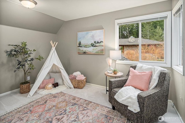 rec room featuring baseboards, lofted ceiling, and carpet flooring