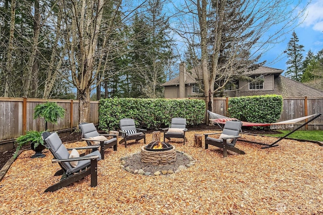 view of yard featuring a fire pit and a fenced backyard