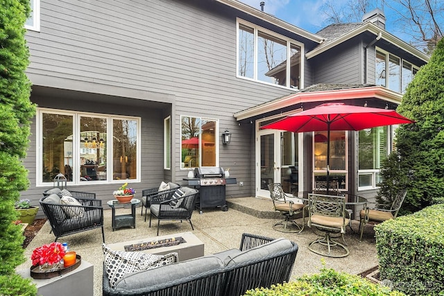 view of patio / terrace with grilling area, an outdoor hangout area, and french doors