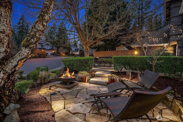 view of patio / terrace featuring an outdoor fire pit and fence