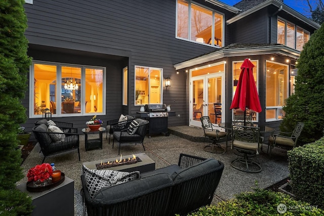 view of patio featuring french doors, an outdoor living space with a fire pit, and grilling area