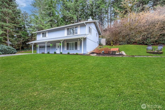 traditional-style home featuring a front lawn and a porch