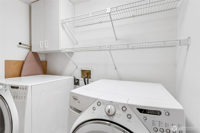 laundry area featuring cabinet space and independent washer and dryer