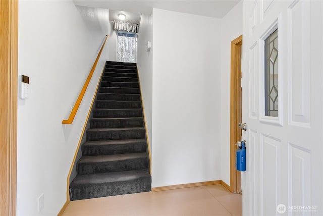 staircase featuring baseboards