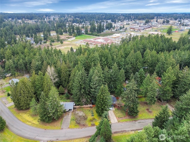 drone / aerial view featuring a forest view