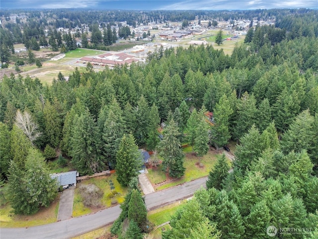 birds eye view of property with a view of trees