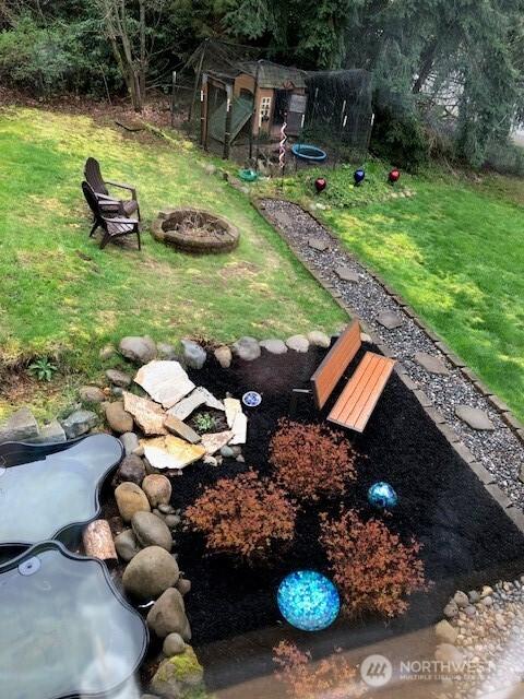 view of yard with a fire pit