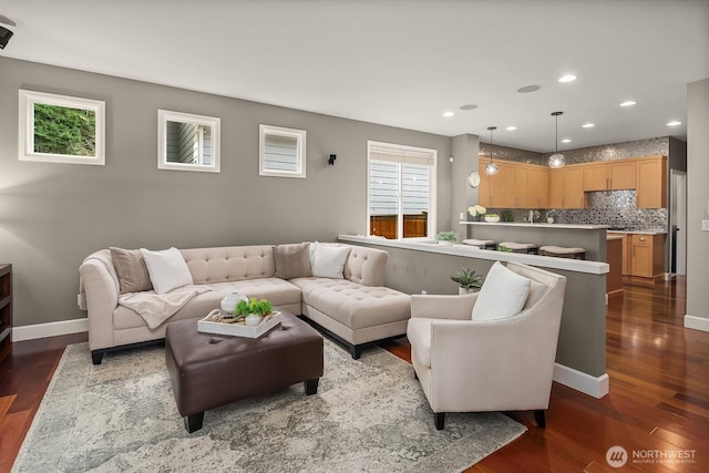 living room featuring plenty of natural light, recessed lighting, and dark wood-style flooring