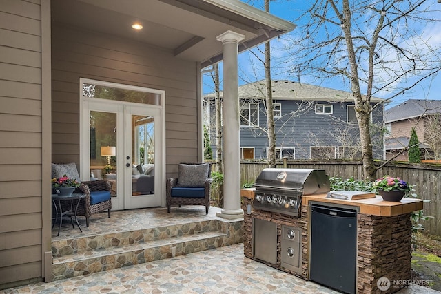 view of patio / terrace featuring french doors, area for grilling, and fence