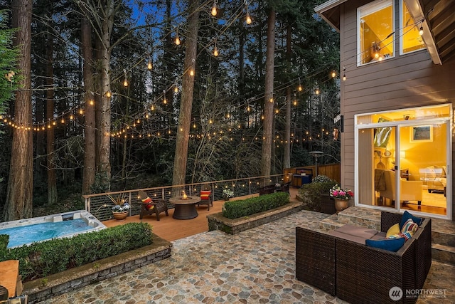 view of patio / terrace with a deck and a hot tub