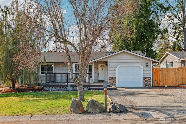 single story home featuring a front yard, fence, a porch, a garage, and stone siding