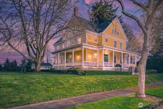 view of front of house featuring a front yard and covered porch